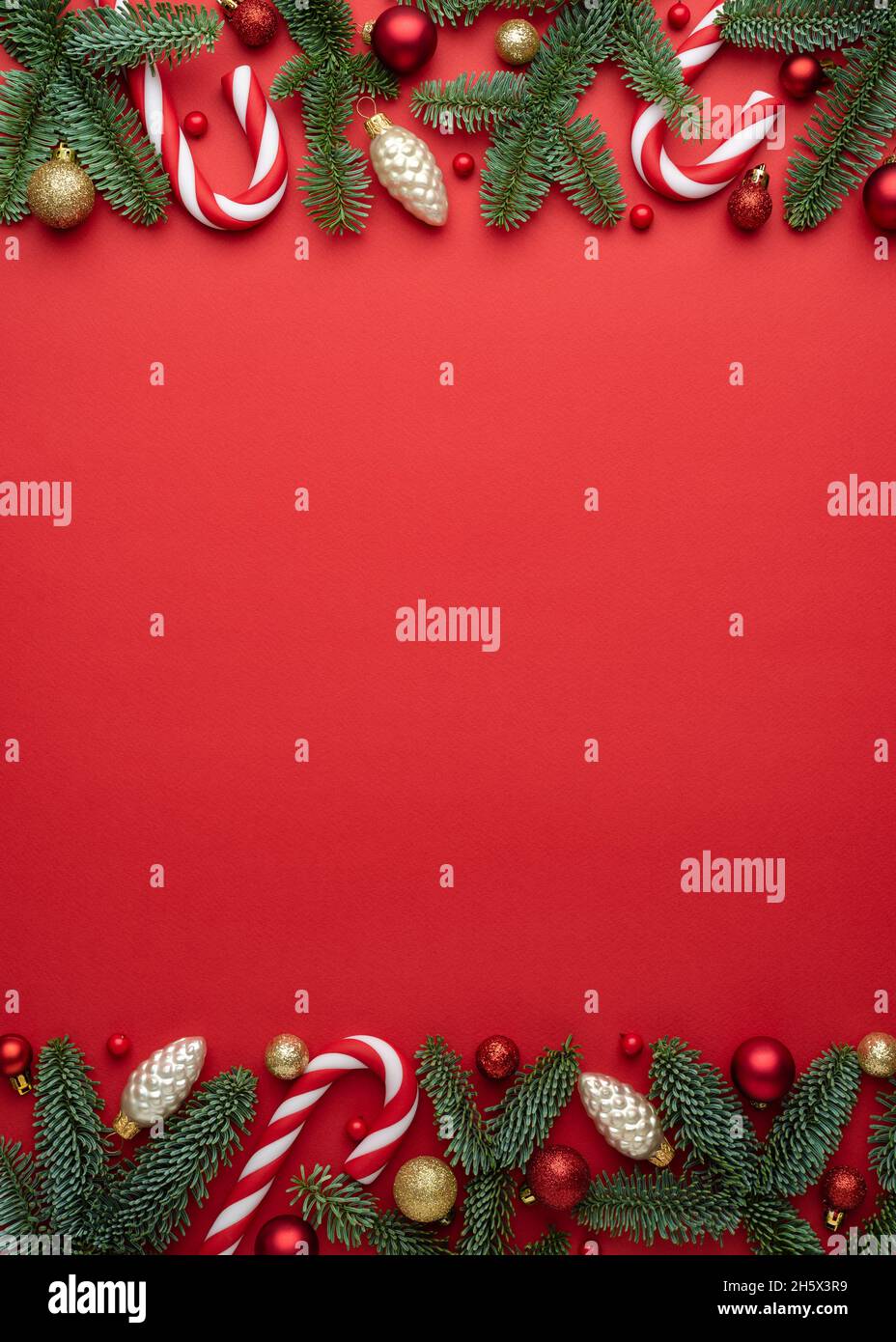 Red background with Christmas decorations made of fir branches and Christmas balls. Blank with copy space for text Stock Photo