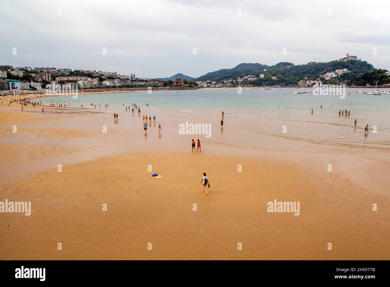Holidaymakers on the  beach at the Spanish seaside holiday resort of San Sebastian in the bay of Biscay Cantabria Northern Spain Stock Photo