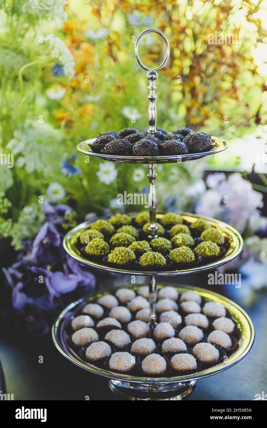 Vertical shot of various types of candies in a multi-layer serving ...