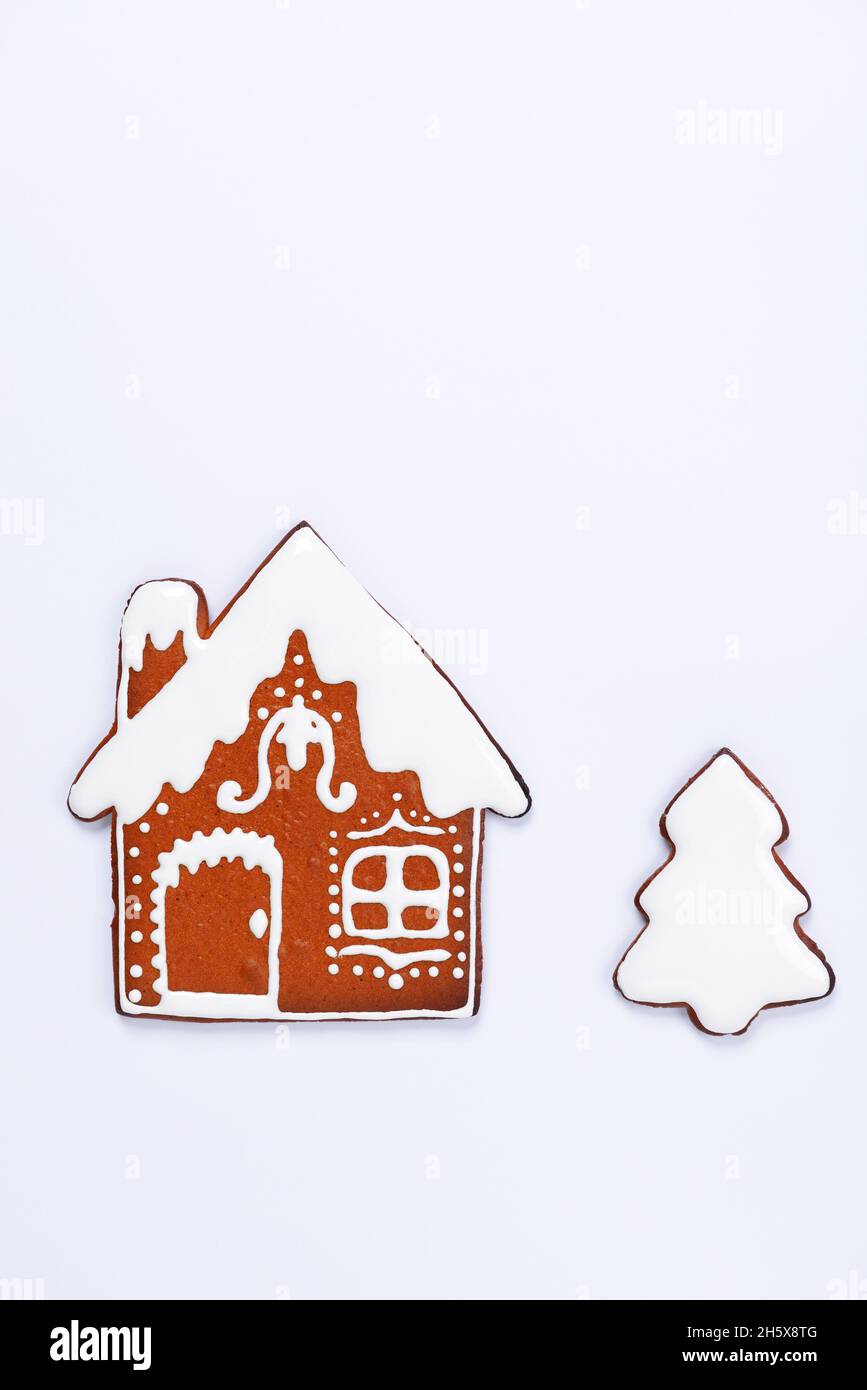 The hand-made eatable gingerbread house and New Year Tree on white background Stock Photo
