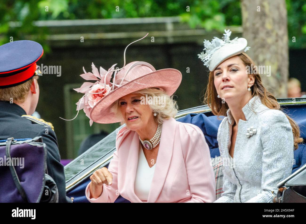 Camilla, Duchess of Cornwall, talking animatedly with Prince Harry