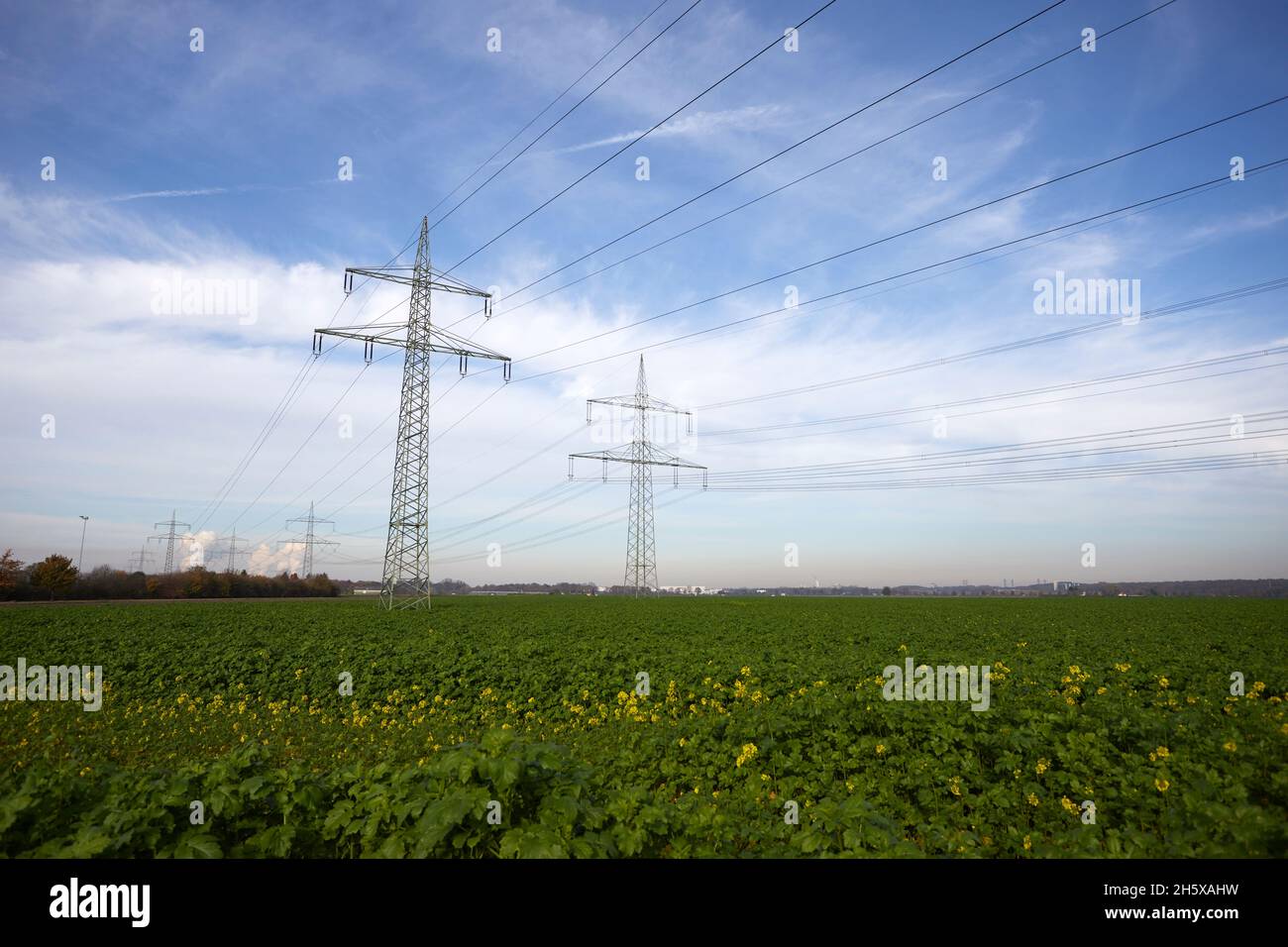 power pylons with power wires with blue sky as background, view from below Stock Photo