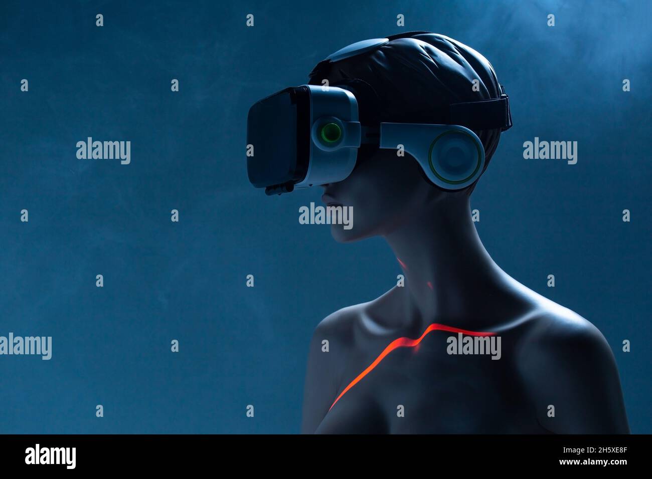 Female dummy with VR goggles placed against bright blue background as symbol of futuristic technology Stock Photo