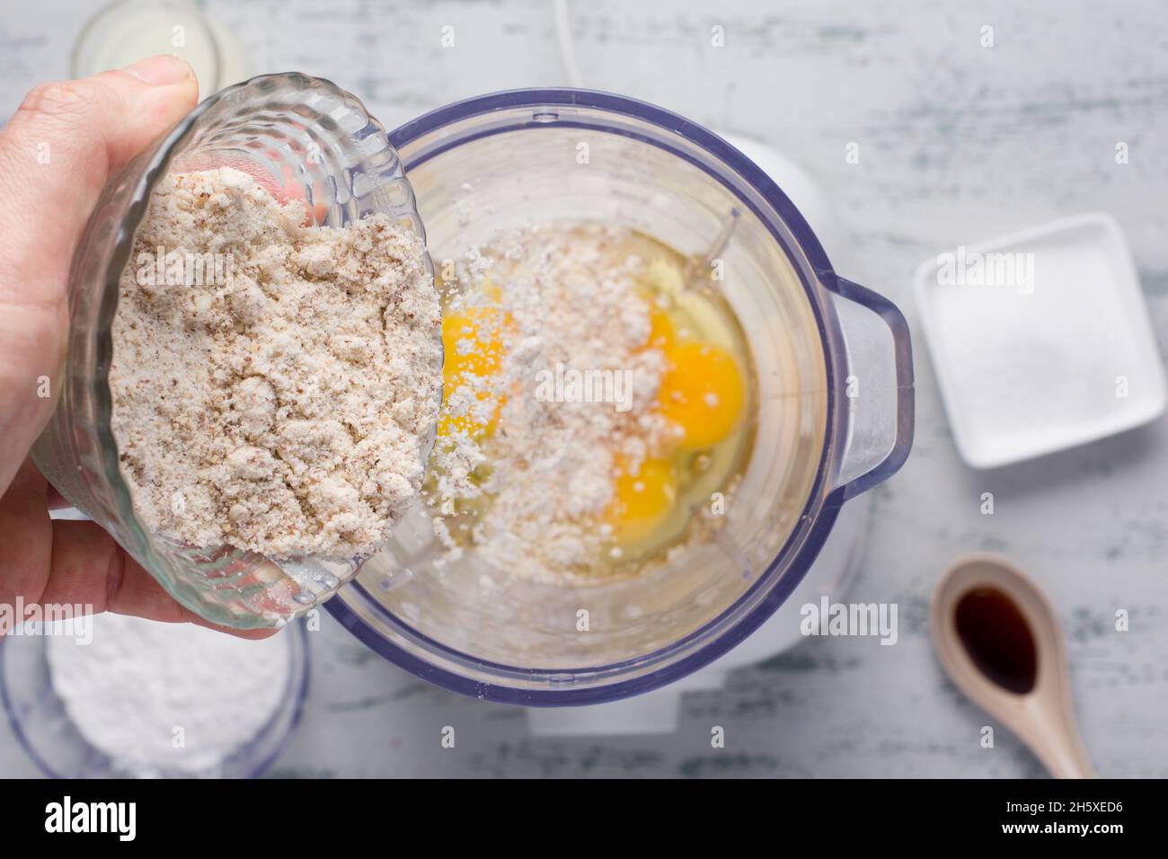 Top view of crop anonymous male pouring healthy almond flour into