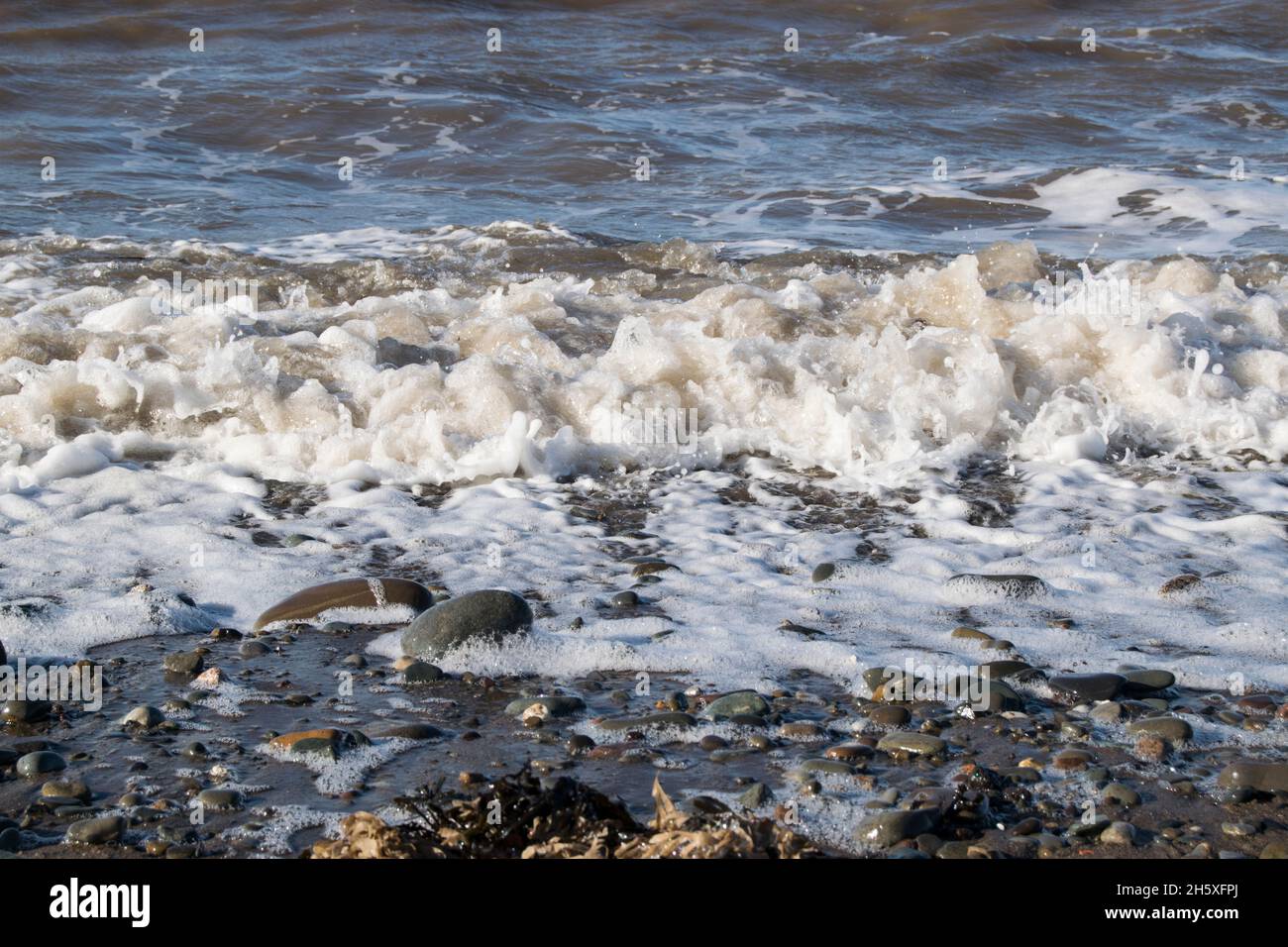 Waves on the Solway coast crashing on the shoreline Stock Photo