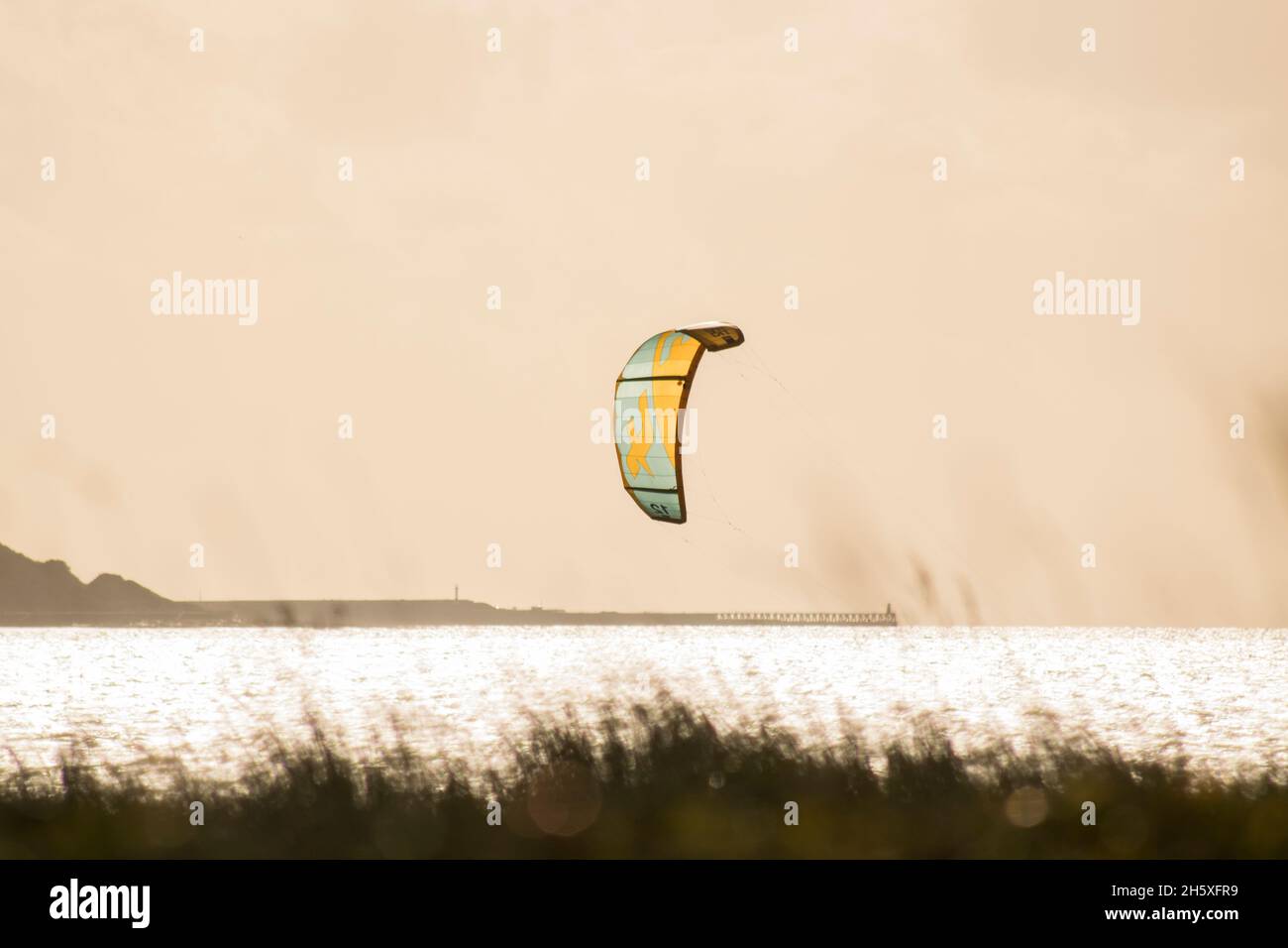 Kite billowing in the wind on the Cumbrian coast on a cold winters day Stock Photo