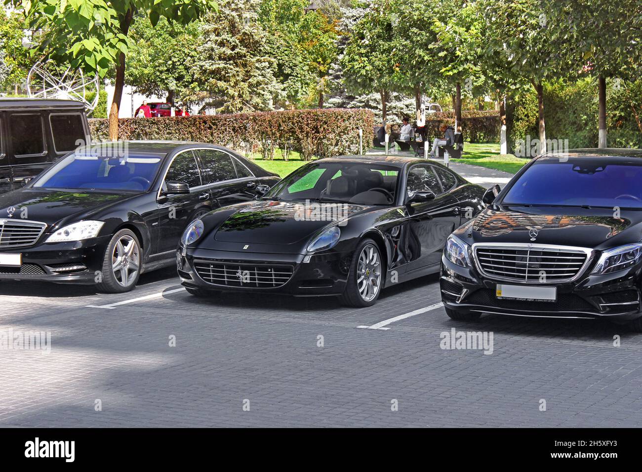 Kiev - Ukraine - September 9, 2017: Beautiful black Ferrari 612 Scaglietti in the parking lot. on the sides of the Mercedes S Stock Photo