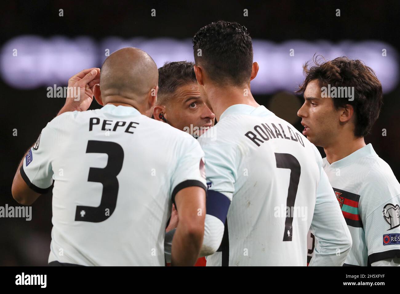 Match referee Jesus Gil Manzano is confronted by Portugal's Pepe, Cristiano Ronaldo and Joao Felix after showing Pepe a red card during the FIFA World Cup Qualifying match at the Aviva Stadium, Dublin. Picture date: Thursday November 11, 2021. Stock Photo