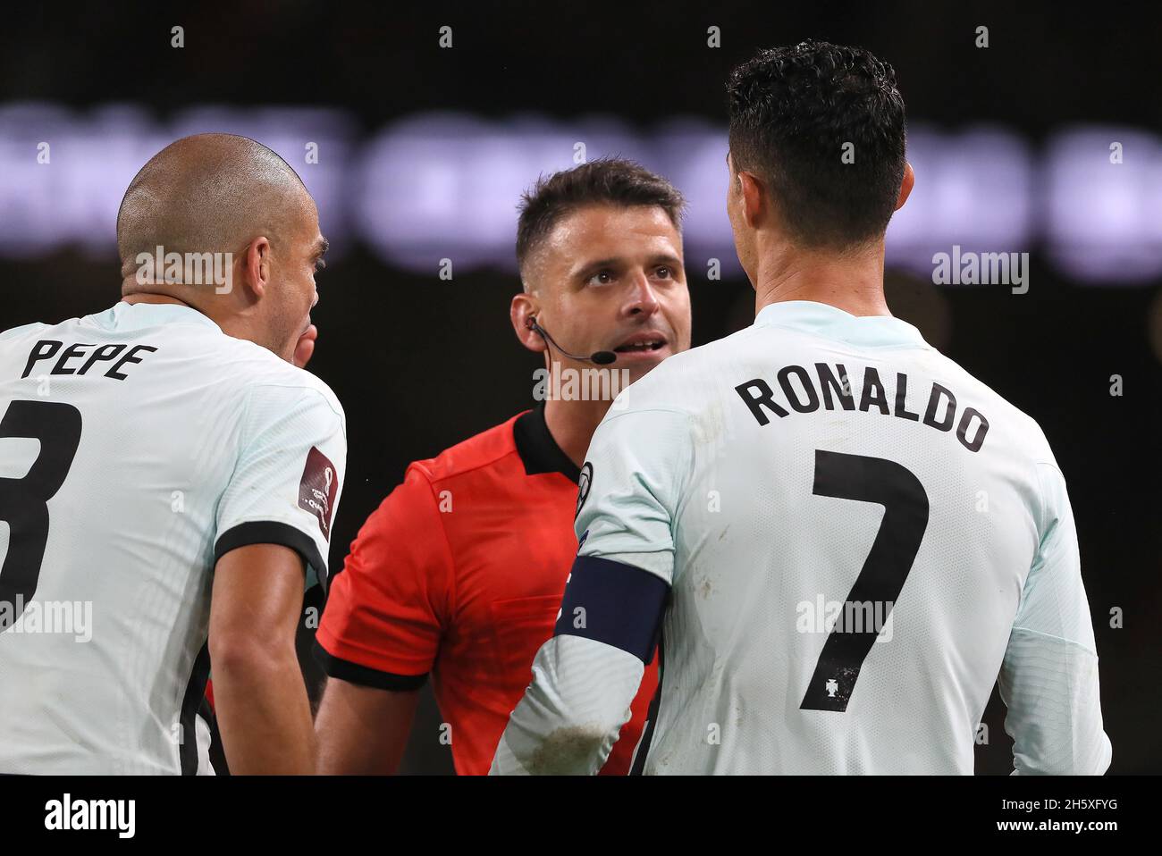Match referee Jesus Gil Manzano is confronted by Portugal's Pepe and Cristiano Ronaldo after showing Pepe a red card during the FIFA World Cup Qualifying match at the Aviva Stadium, Dublin. Picture date: Thursday November 11, 2021. Stock Photo