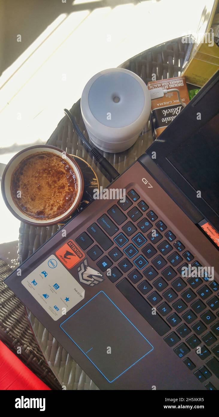 KARACHI, PAKISTAN Oct 14, 2021 A laptop and a cup of hot coffee on a