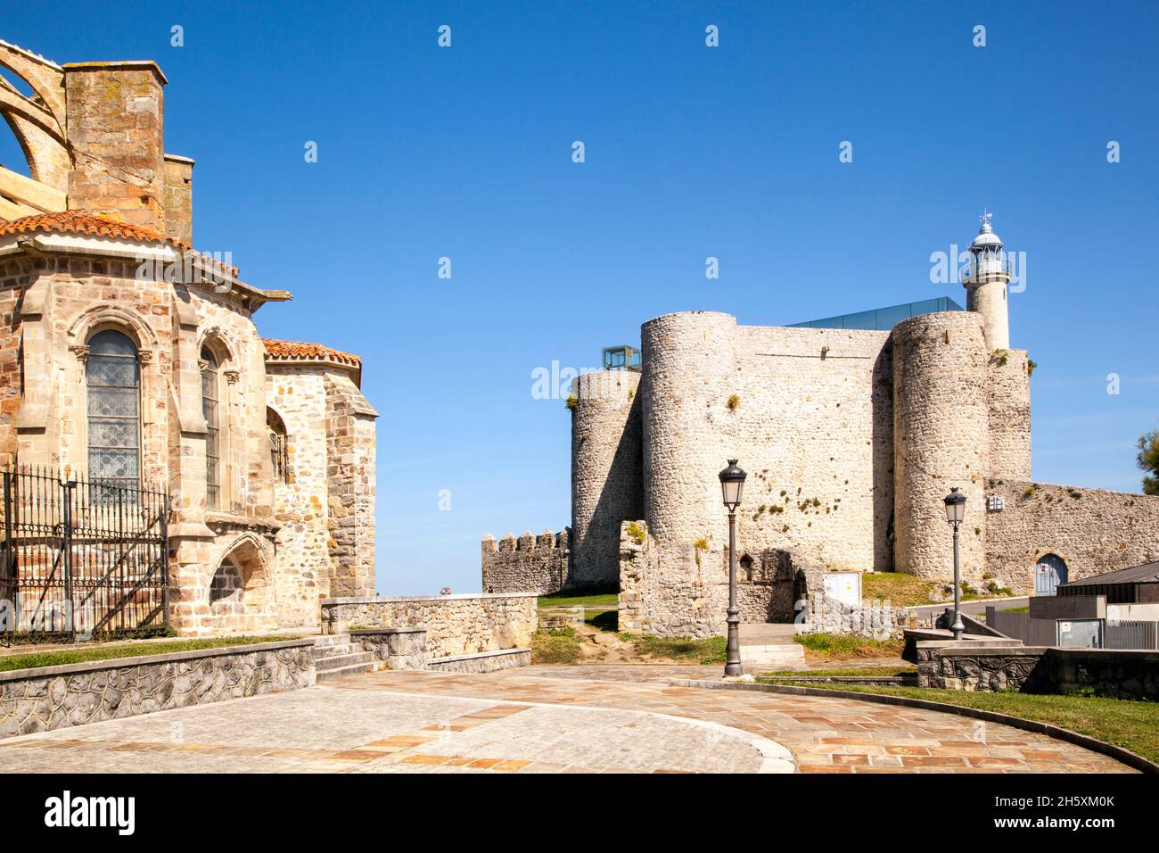 The medieval castle of Santa Ana now used to house the lighthouse and the Church of Santa María de la Asunción   at Castro Urdiales Northern Spain Stock Photo