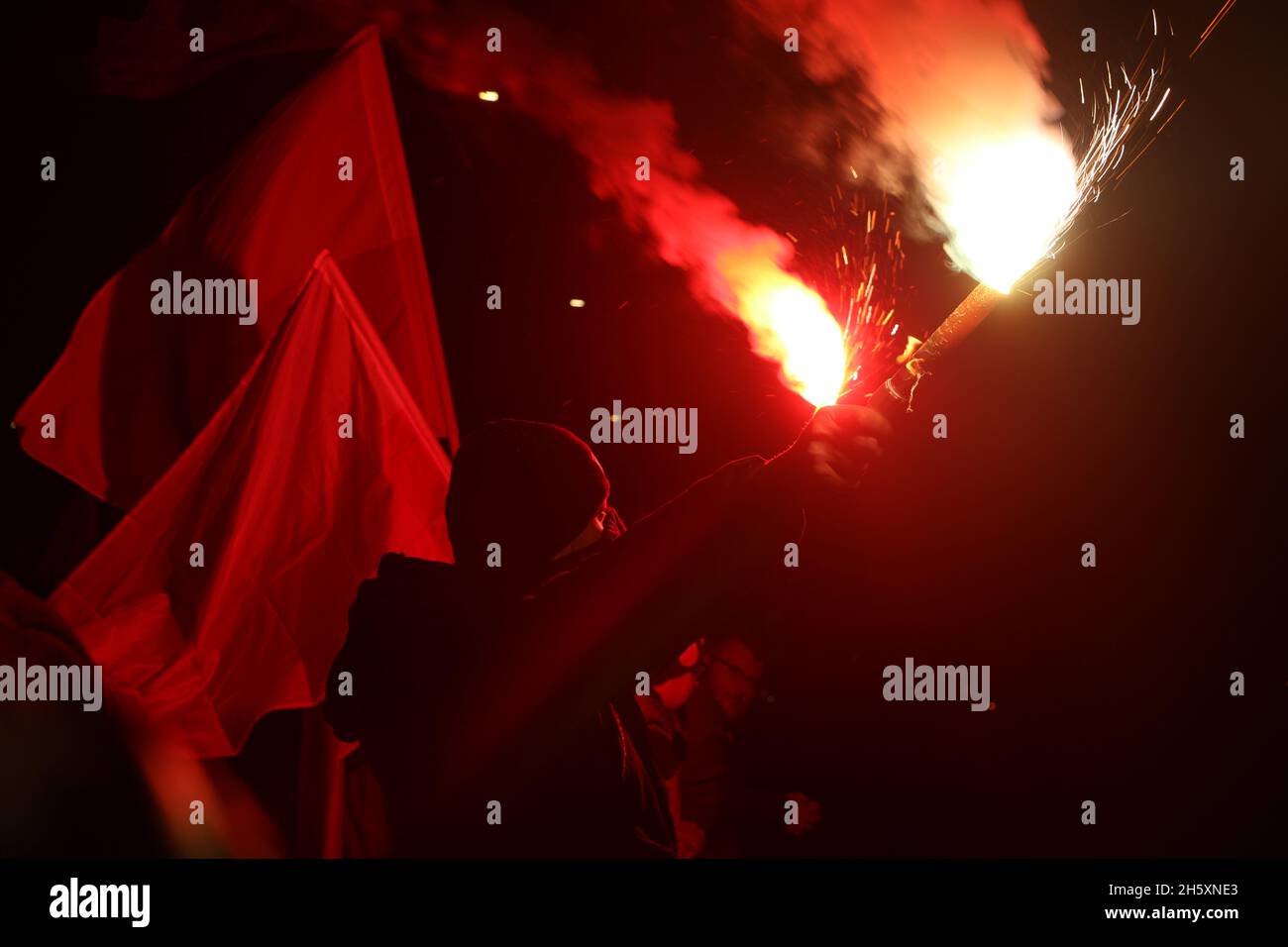 Protester lights flares at Polish nationalist march. Stock Photo