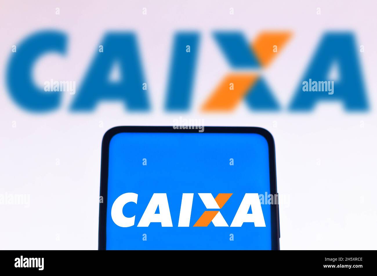 In this photo illustration the Caixa Econômica Federal (CEF) logo seen displayed on a smartphone screen and in the background. Stock Photo