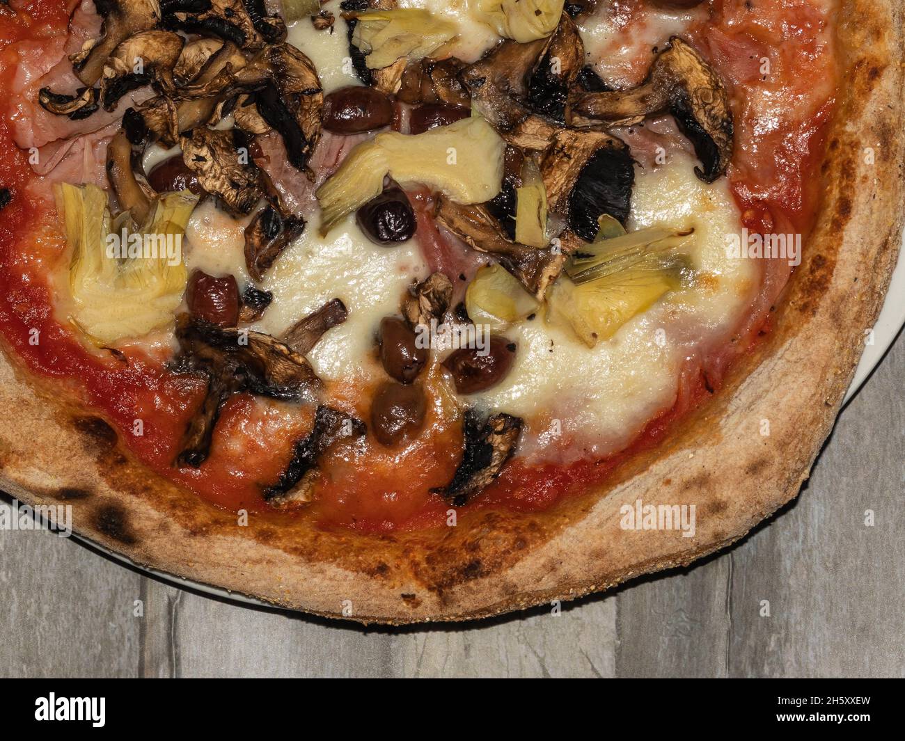 detail of stuffed pizza on wooden Stock Photo