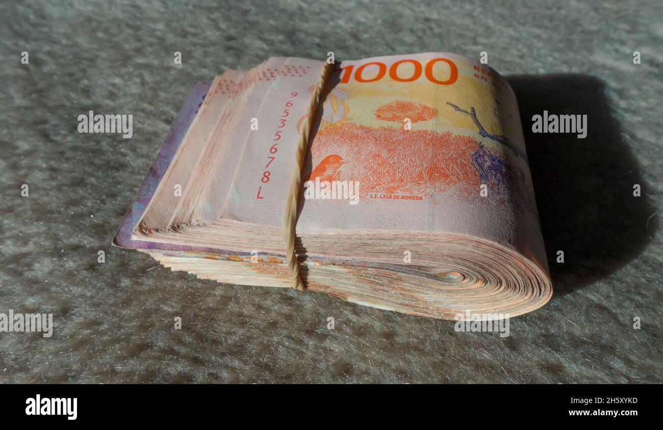 wad of bank notes tied with elastic band Stock Photo