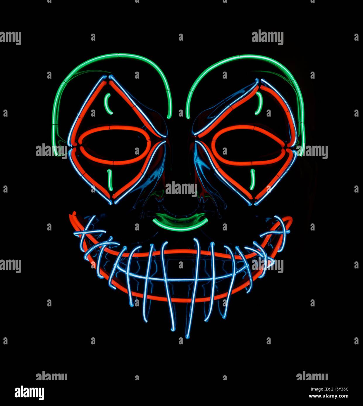 LED Scary Clown Mask Glowing in Red, Green, and Blue. Stock Photo