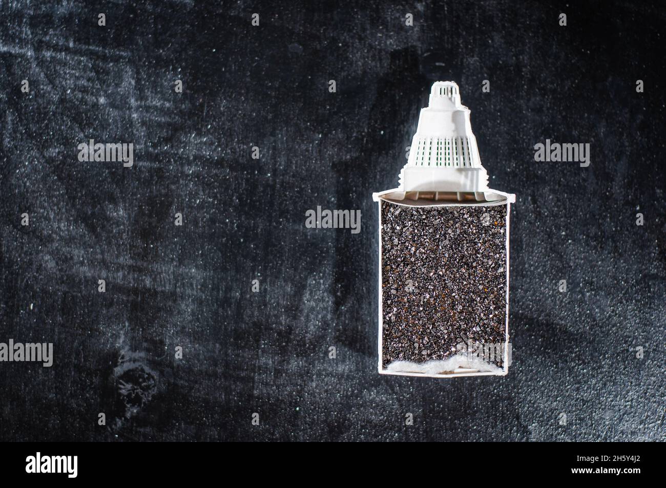 Cutaway of the water charcoal filter module on a dark background Stock Photo