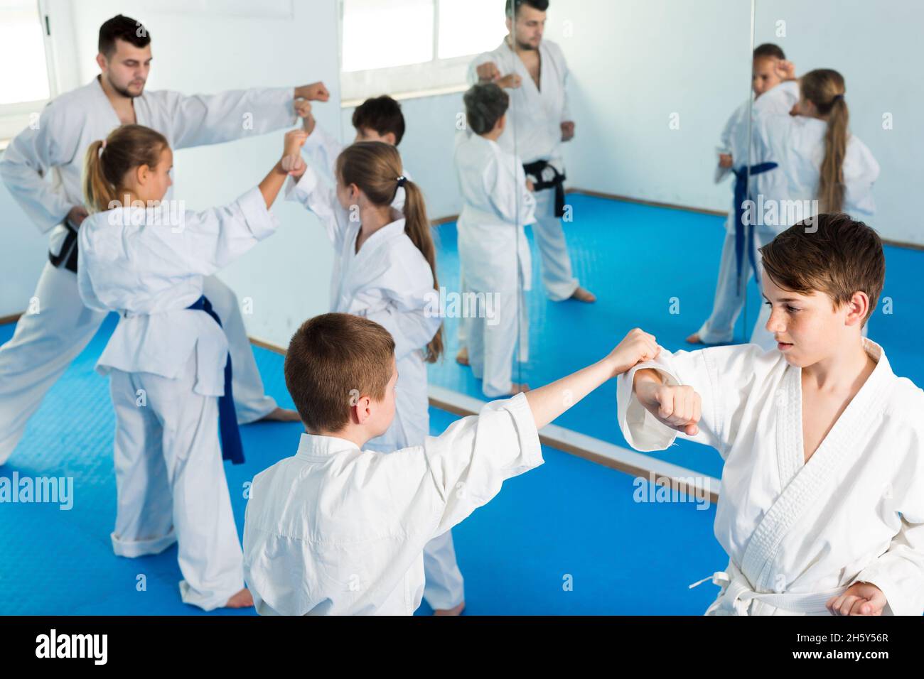 Glad children sparring in pairs in karate class Stock Photo - Alamy