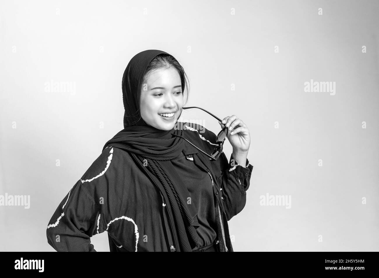 Indonesian female Muslim wearing hijab  in black and white portrait Stock Photo