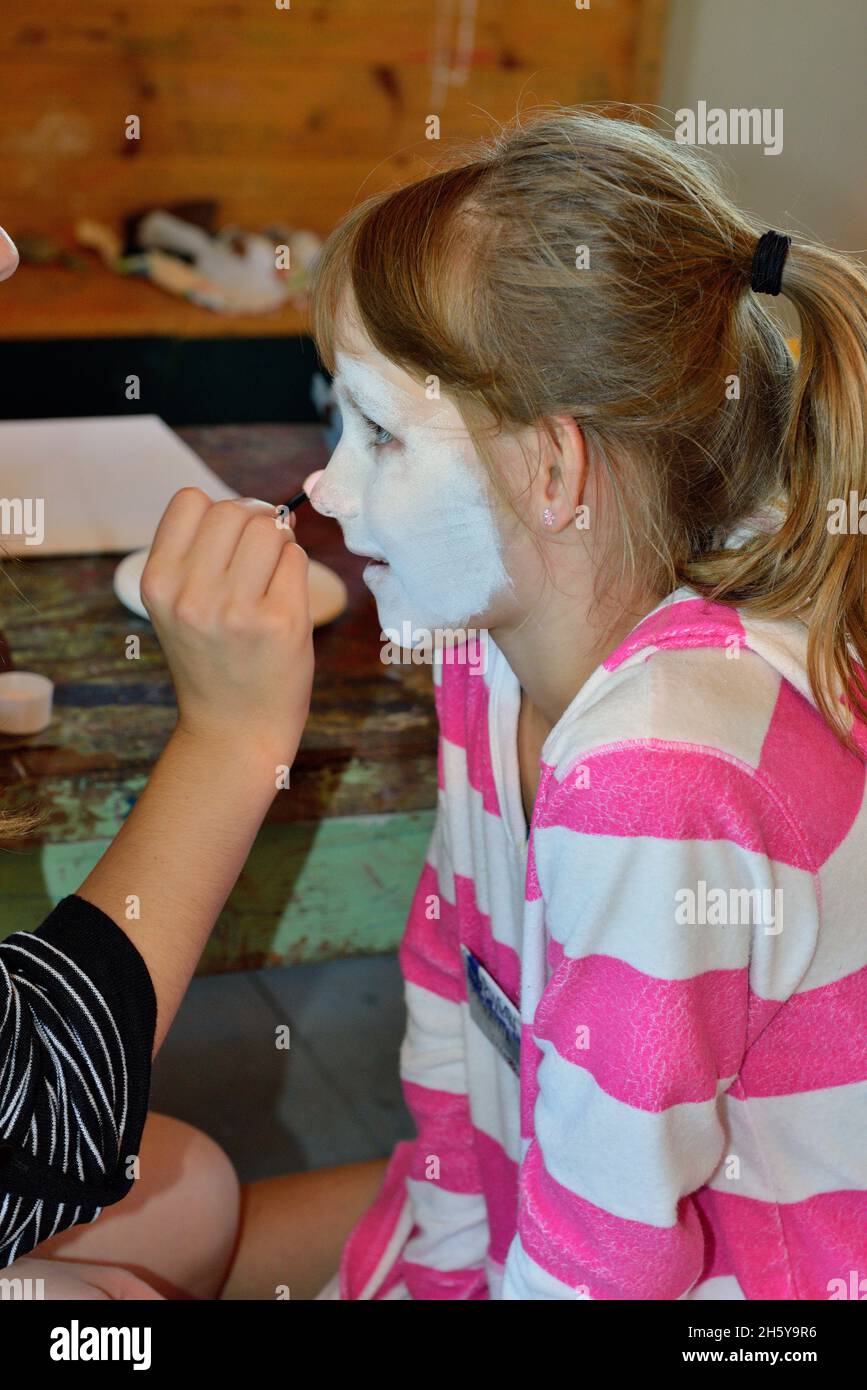 Face painting at a family gathering, Greater Sudbury, Ontario, Canada Stock Photo