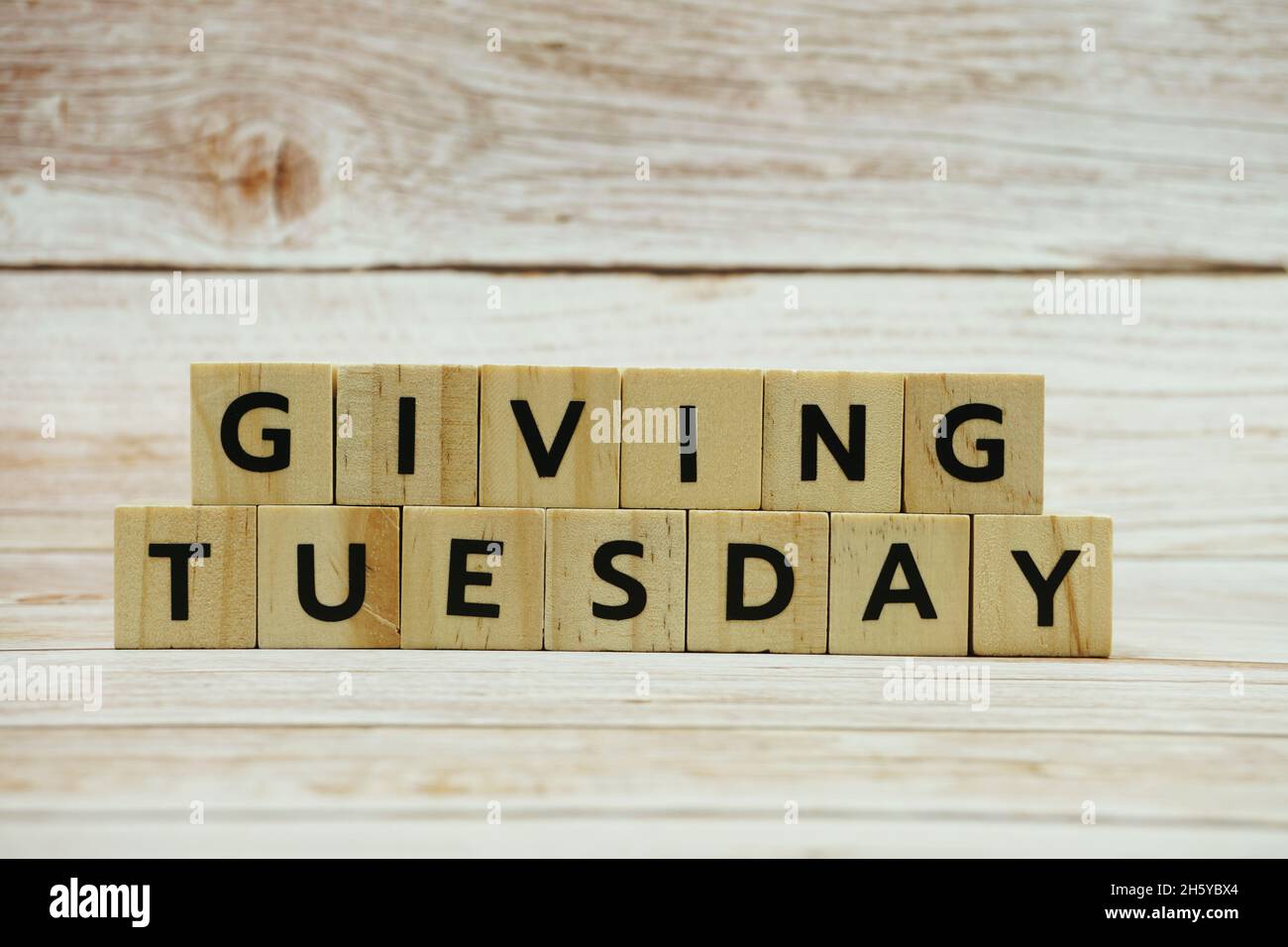 Giving Tuesday alphabet letter on wooden background Stock Photo