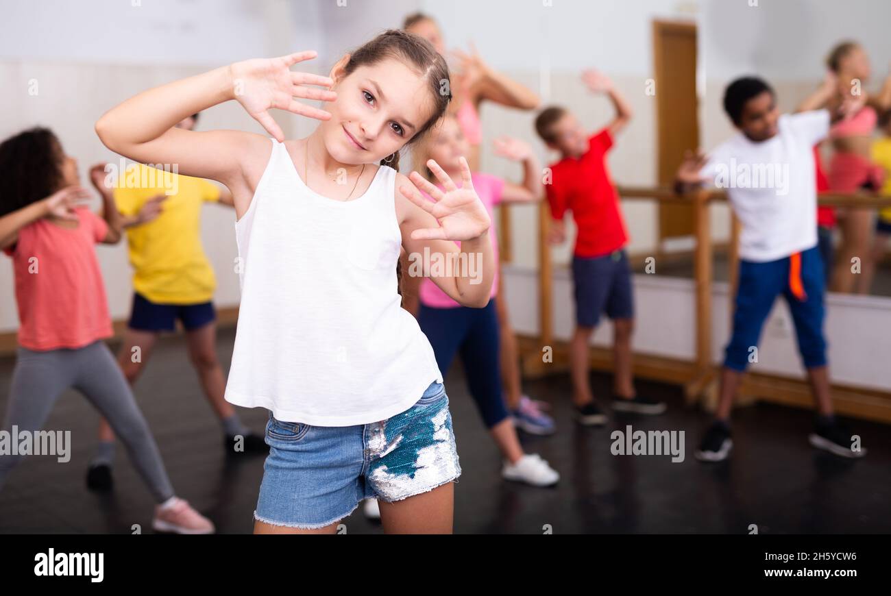 Girl exercising in group during dance class Stock Photo