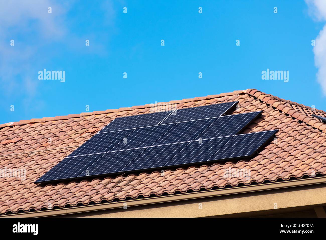 Solar panels installed on the tile roof. Blue sky Stock Photo Alamy