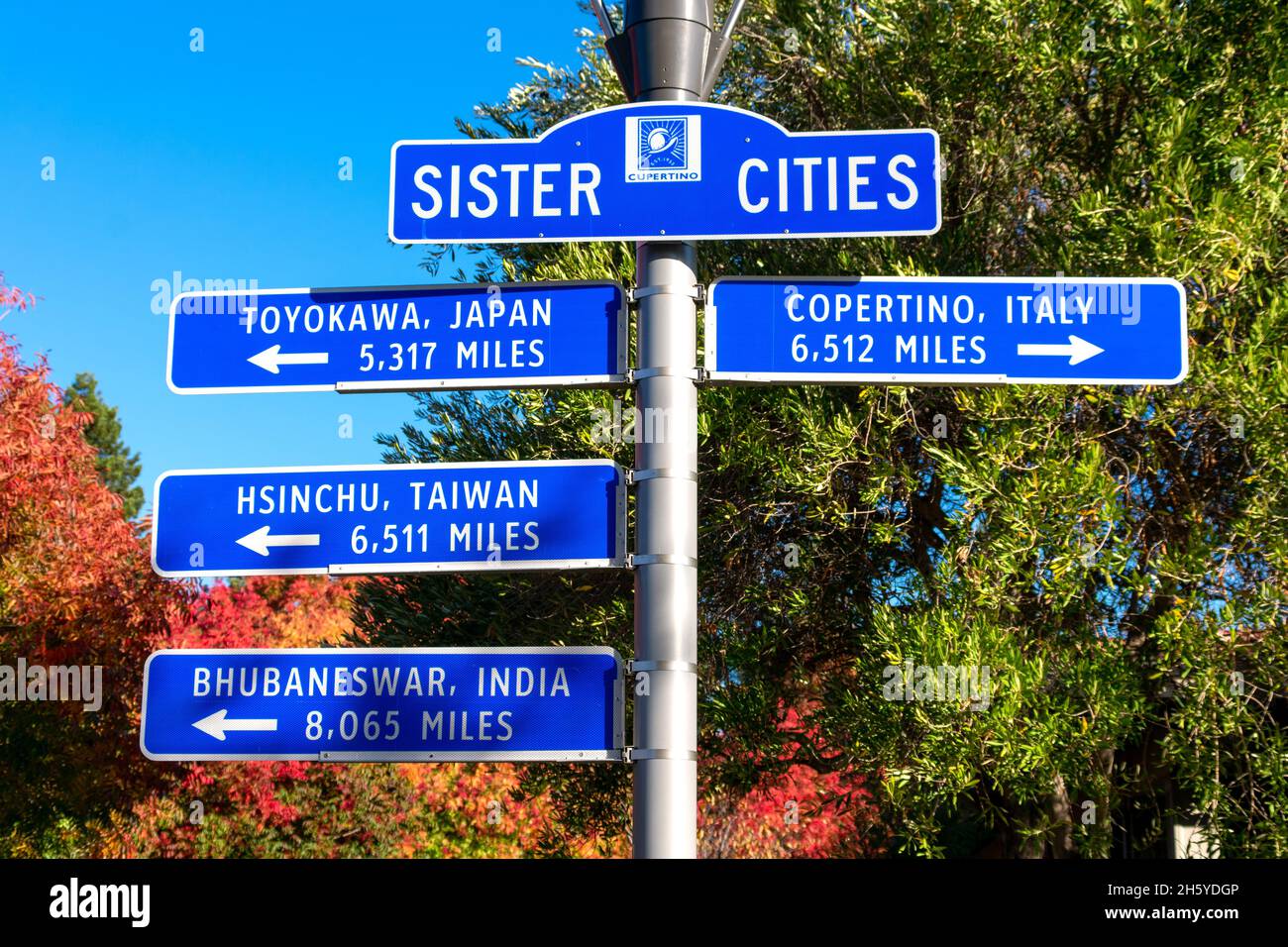 Sign featuring the names of Cupertino sister cities and pointing in the