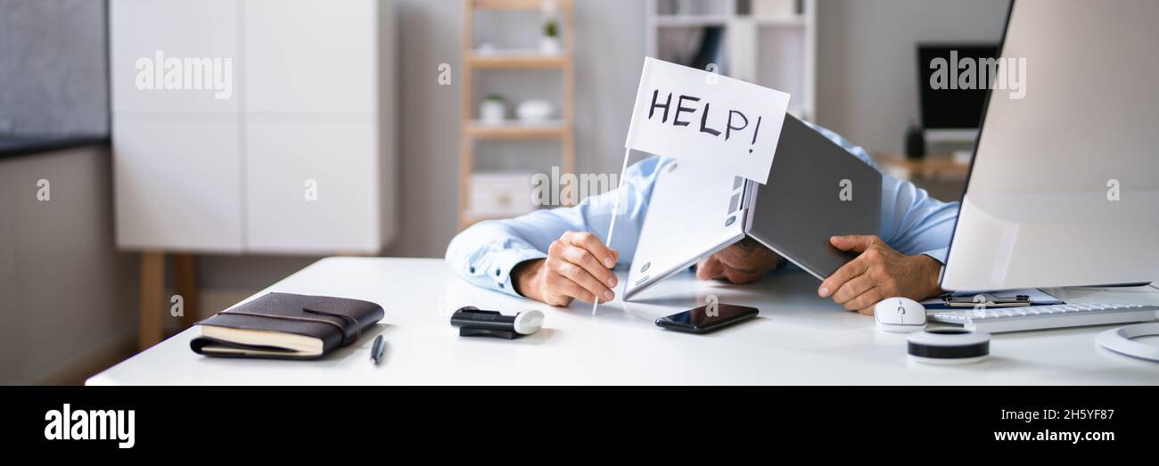 Tech Overload And Employee Trouble At Work In Office Stock Photo