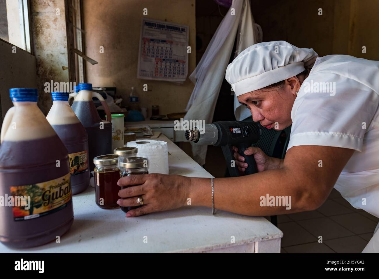 July 2017. Melinda Bacani processes and packages raw honey at the the Nagkakaisang Tribu ng Palawan (NATRIPAL) or the United Tribes of Palawan offices. Puerto Princesa, Palawan, Philippines. Stock Photo