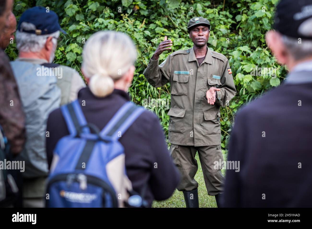 September 2017. David Agenya, Head Ranger at the Bwindi Impenetrable National Park Buhoma Head Quarters, briefs tourists before the daily gorilla tracking tour. Buhoma, Uganda. Stock Photo