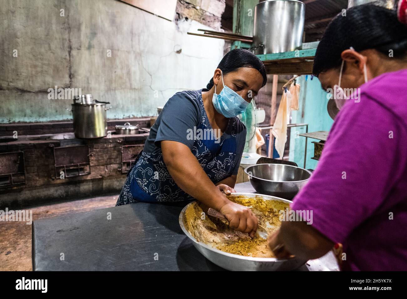 July 2017. Kitchen Staff, Febelyn Balao (left) and Nide Alvarez (rigth) prepare ginger tea powder. The Kalihan Educational Foundation (KEF) runs a small jam, jelly, and other prepared foods making operation as part of their enterprise development programs. Imugan, Nueva Vizcaya, Philippines. Stock Photo
