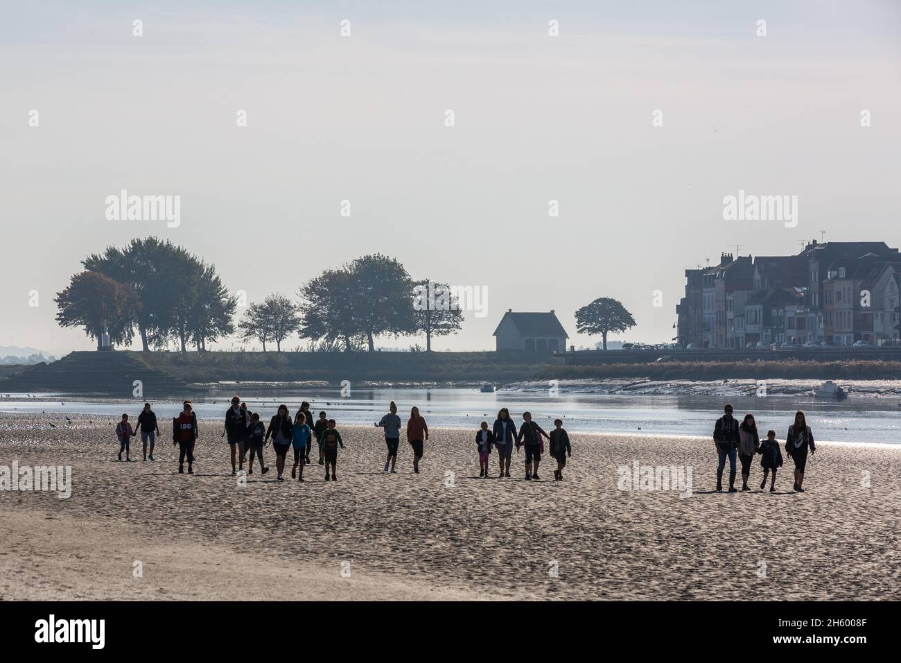 Group of hikers crossing the Baie de Somme at low tide. Saint-Valery, France Stock Photo