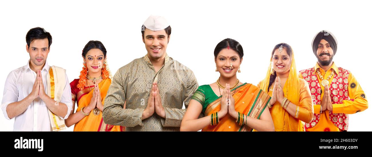 Indian couple of different state and cultures standing and greeting with hands joined. Stock Photo