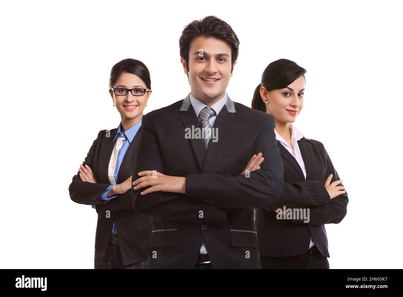 A team of corporate employees standing together with crossed arms in