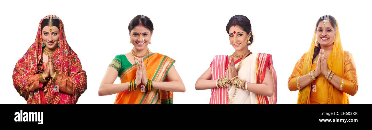 Indian women in traditional cultural dresses greeting with their hands joined. Stock Photo