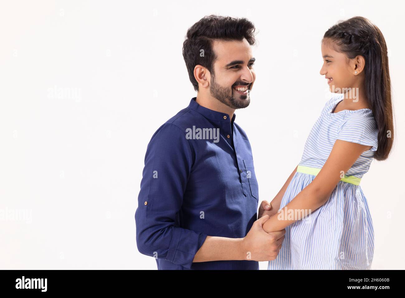 A HAPPY FATHER AND DAUGHTER LOOKING AT EACH OTHER Stock Photo