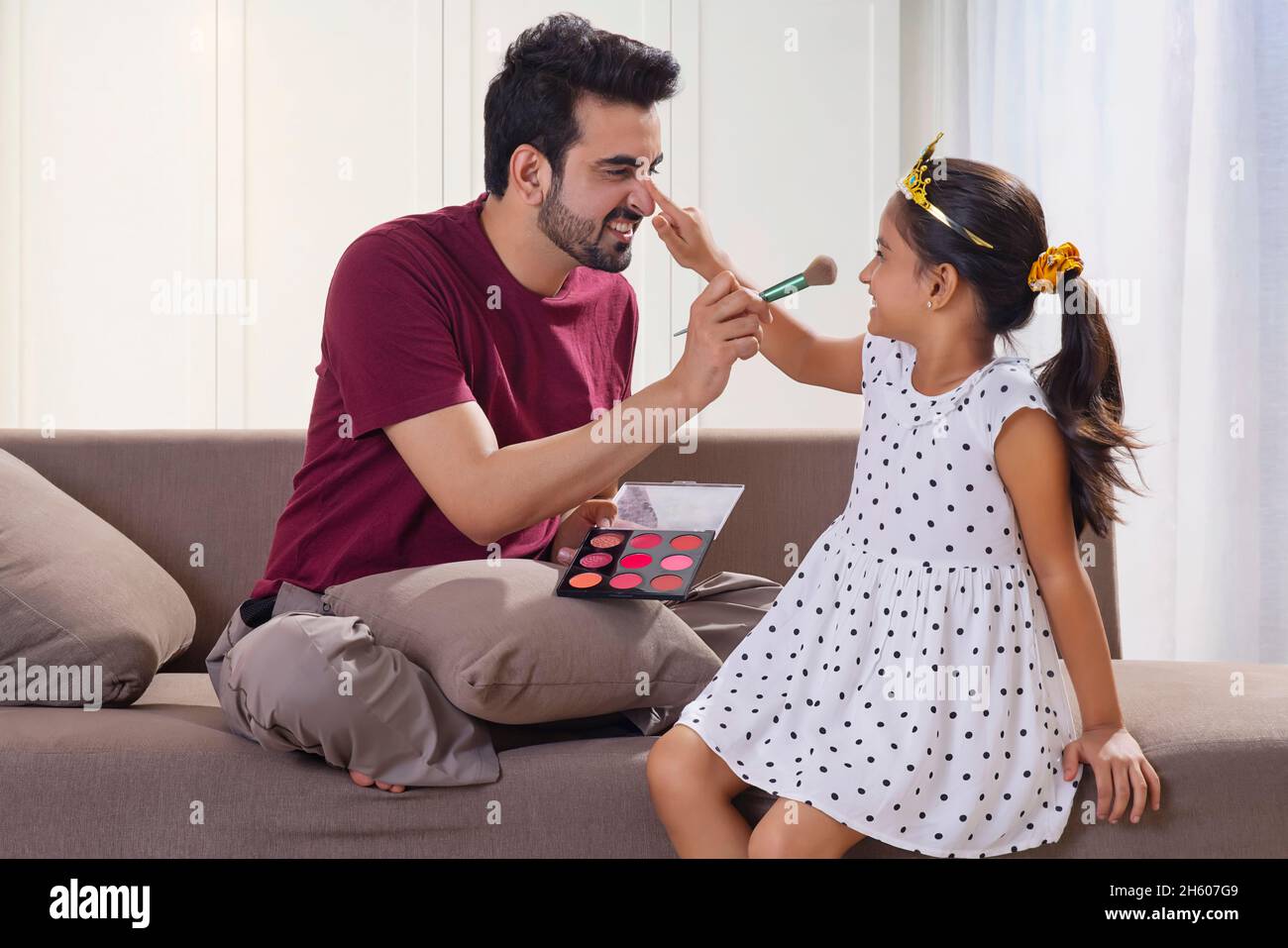A FATHER AND DAUGHTER HAPPILY PLAYING TOGETHER AT HOME Stock Photo - Alamy