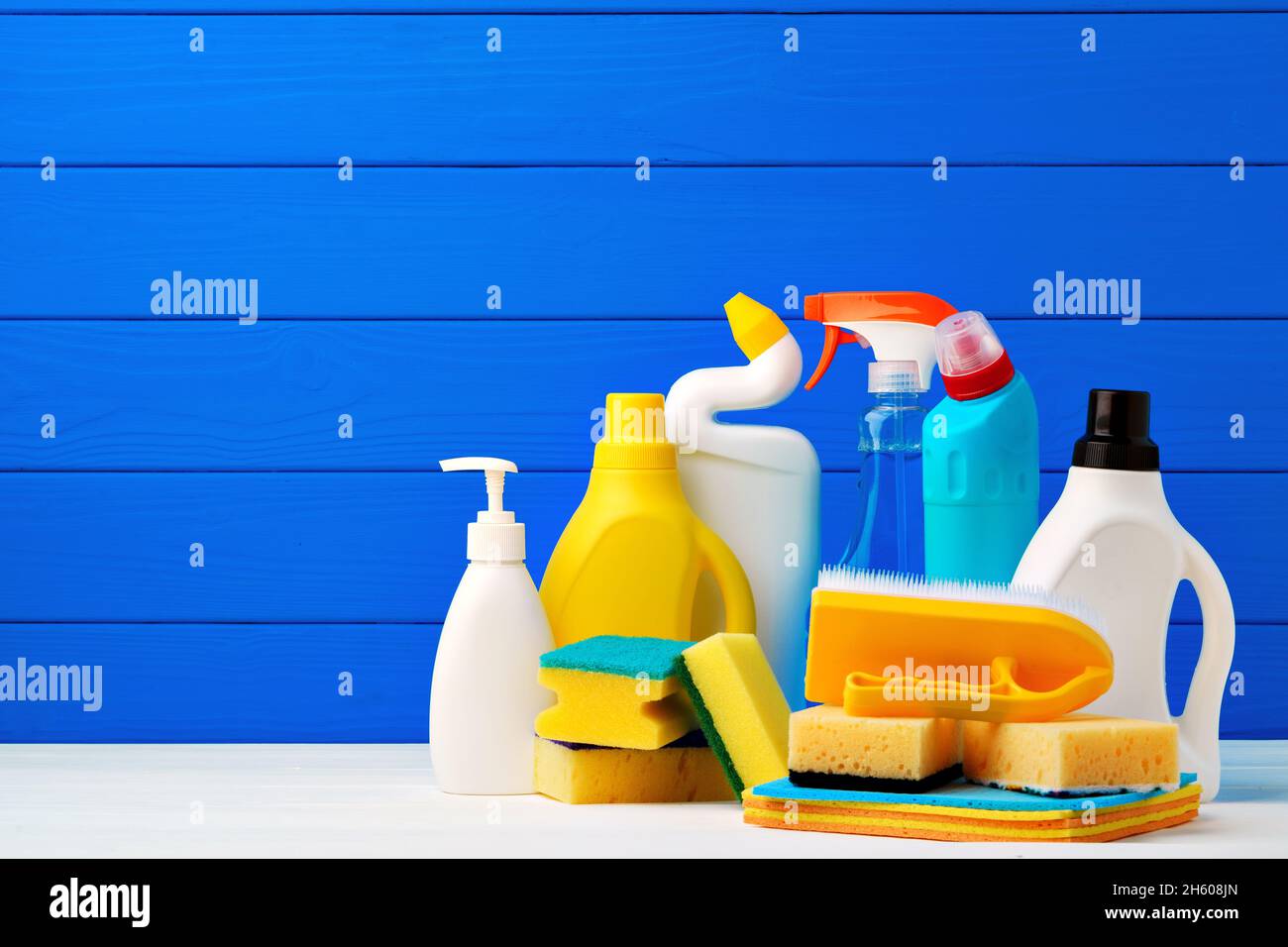 https://c8.alamy.com/comp/2H608JN/various-cleaning-items-against-blue-wooden-background-2H608JN.jpg