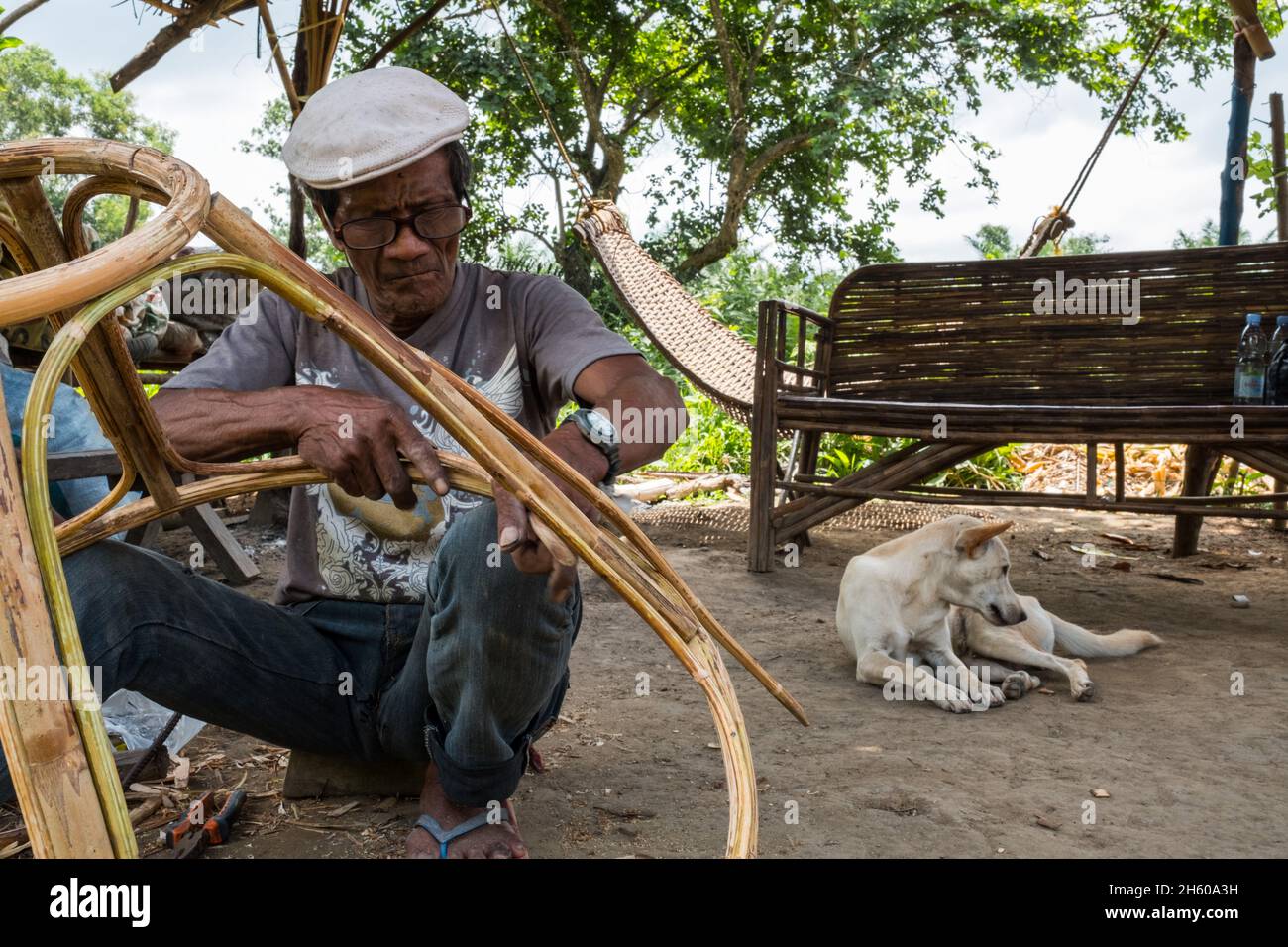 July 2017. Arenesto Deguen making an infant's walker from rattan. Local