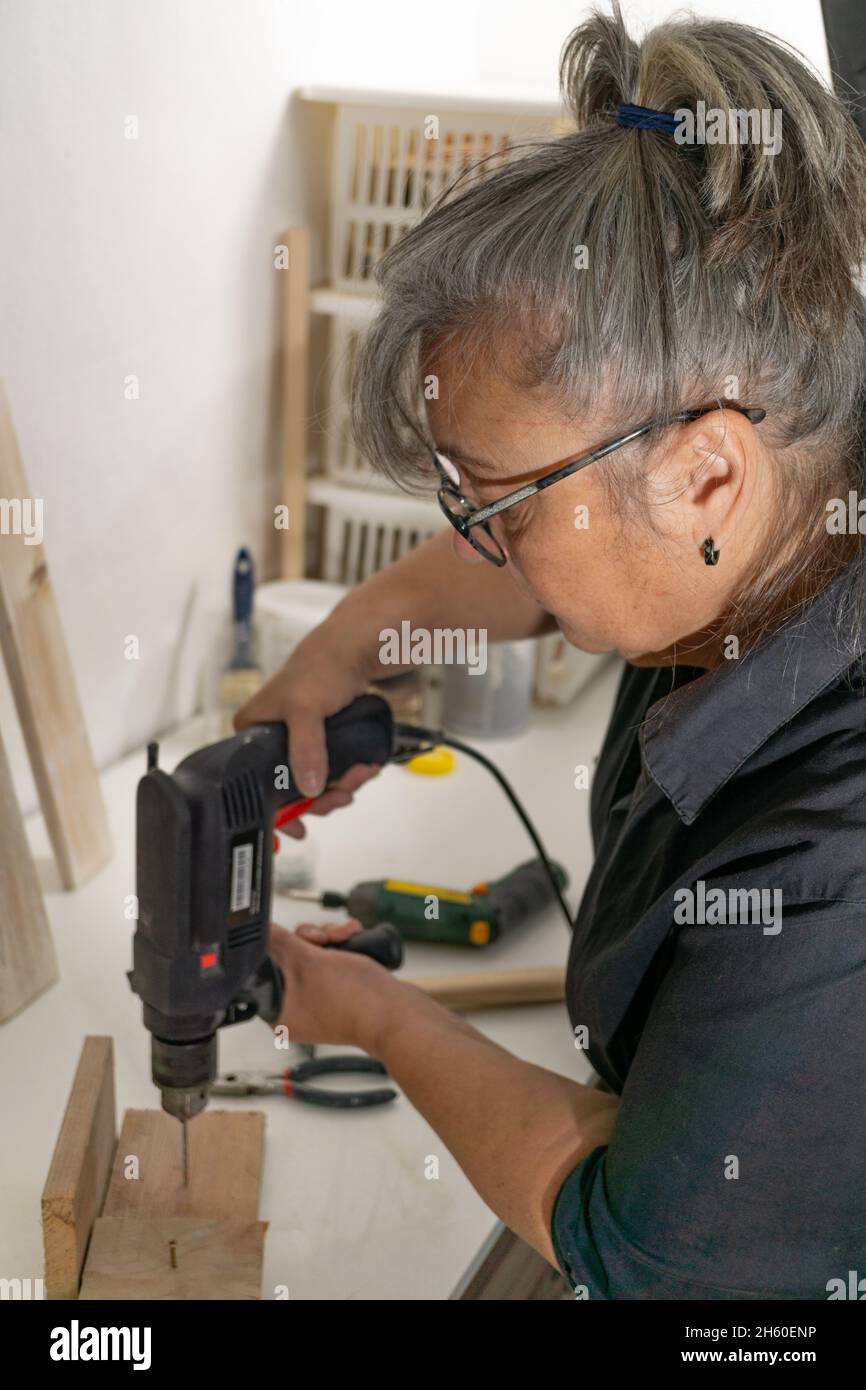 older woman working in her workshop Stock Photo - Alamy