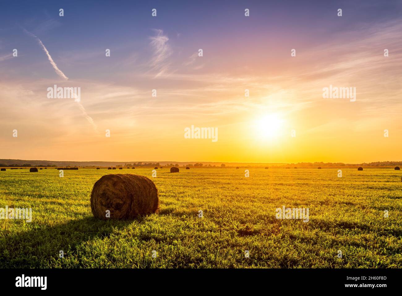 A field with haystacks on a summer or early autumn evening with a ...