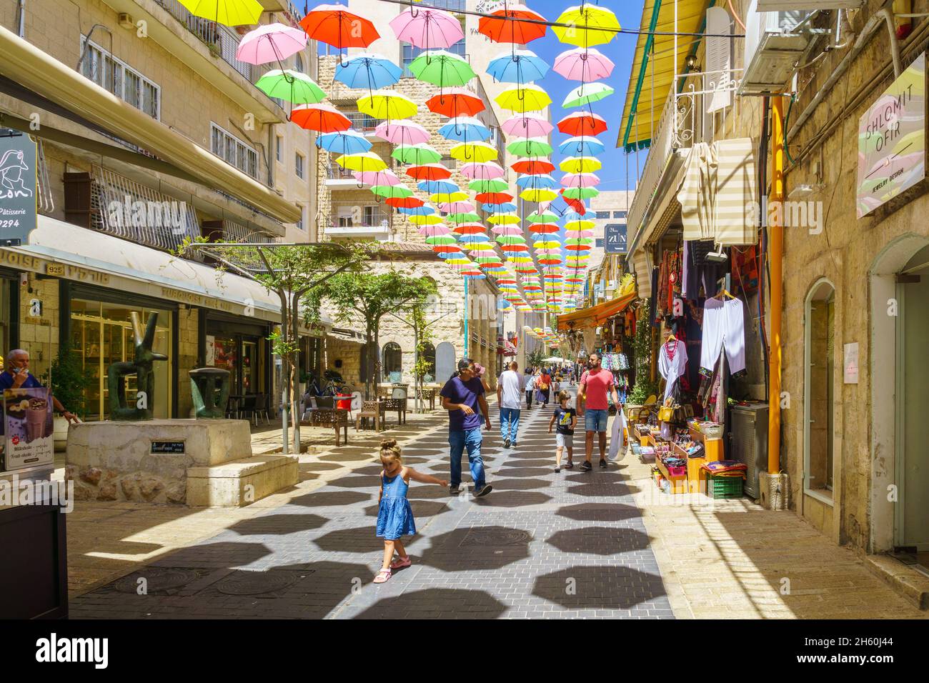 Jerusalem, Israel - August 30, 2021: Pedestrians and colorful umbrellas (parasols), in Yoel Moshe Solomon Street, the historic Nachalat Shiva neighbor Stock Photo