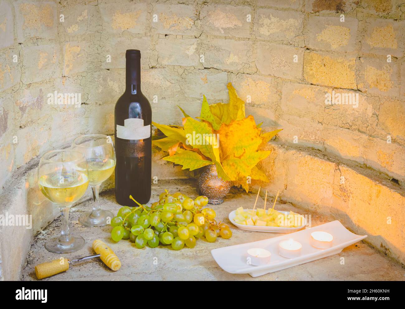 Georgian red wine bottle set up with glasses of wien and other autumn