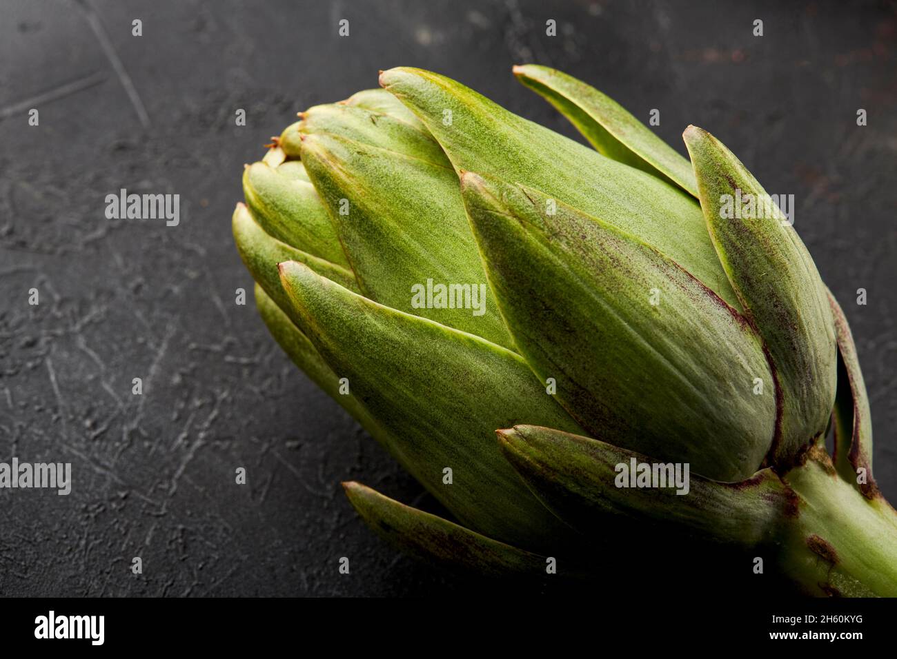 Artichokes on a black background. Stock Photo