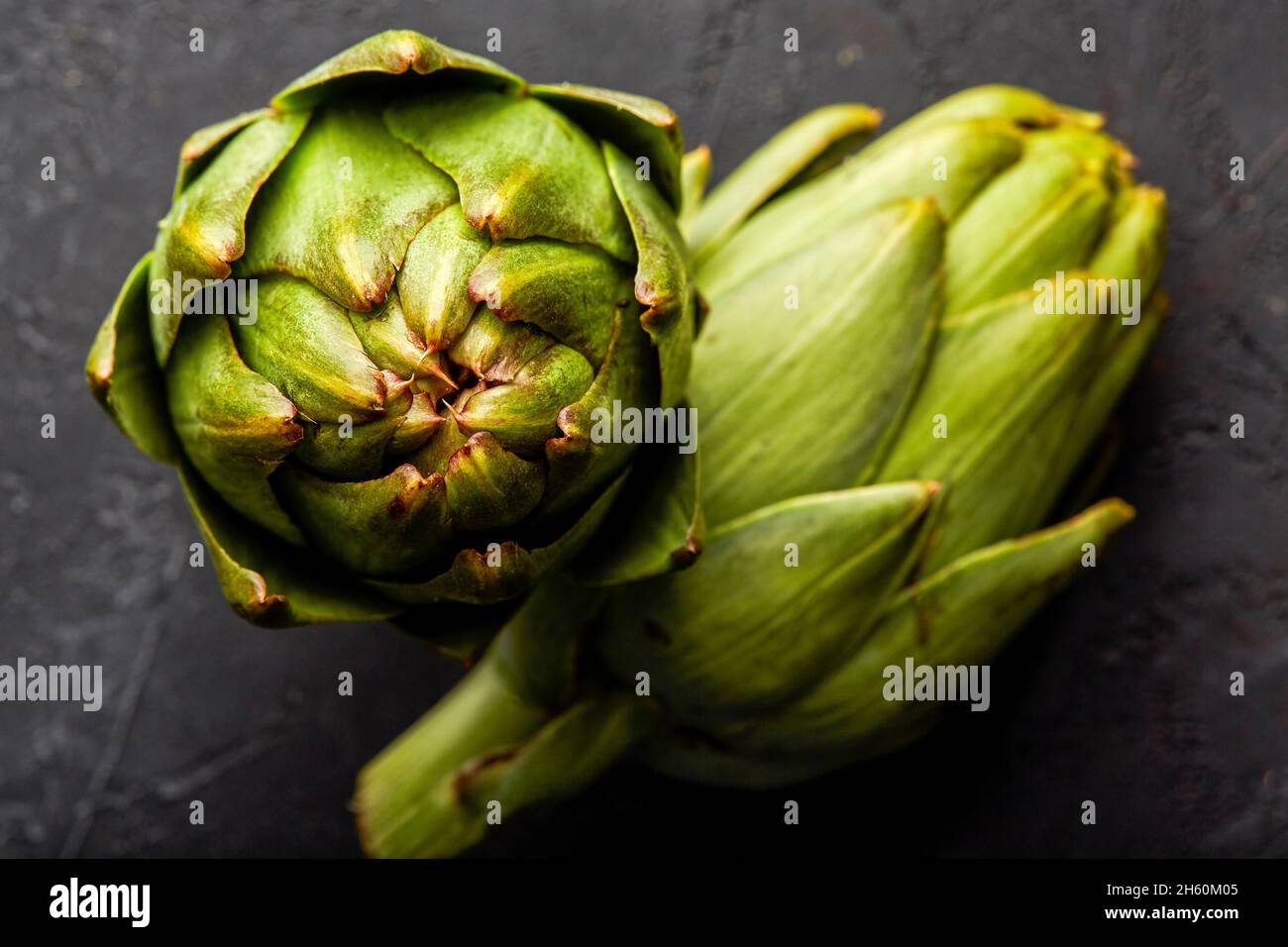 Artichokes on a black background. Stock Photo