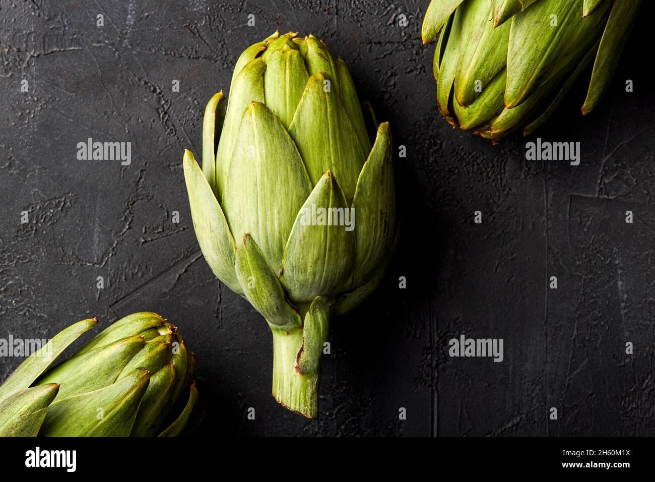 Artichokes on a black background. Stock Photo