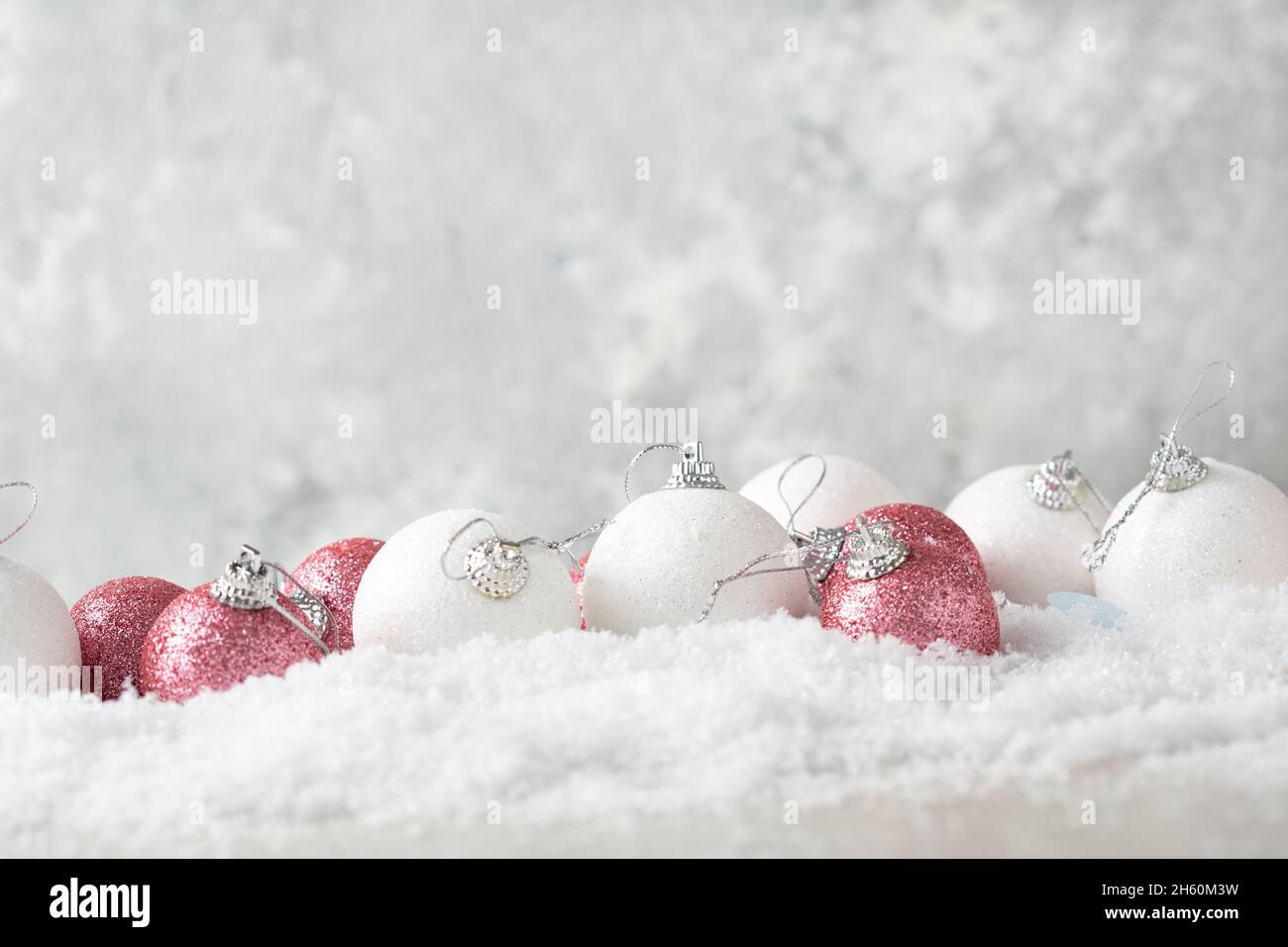 Christmas background with snow and white and pink balls holiday concept Stock Photo