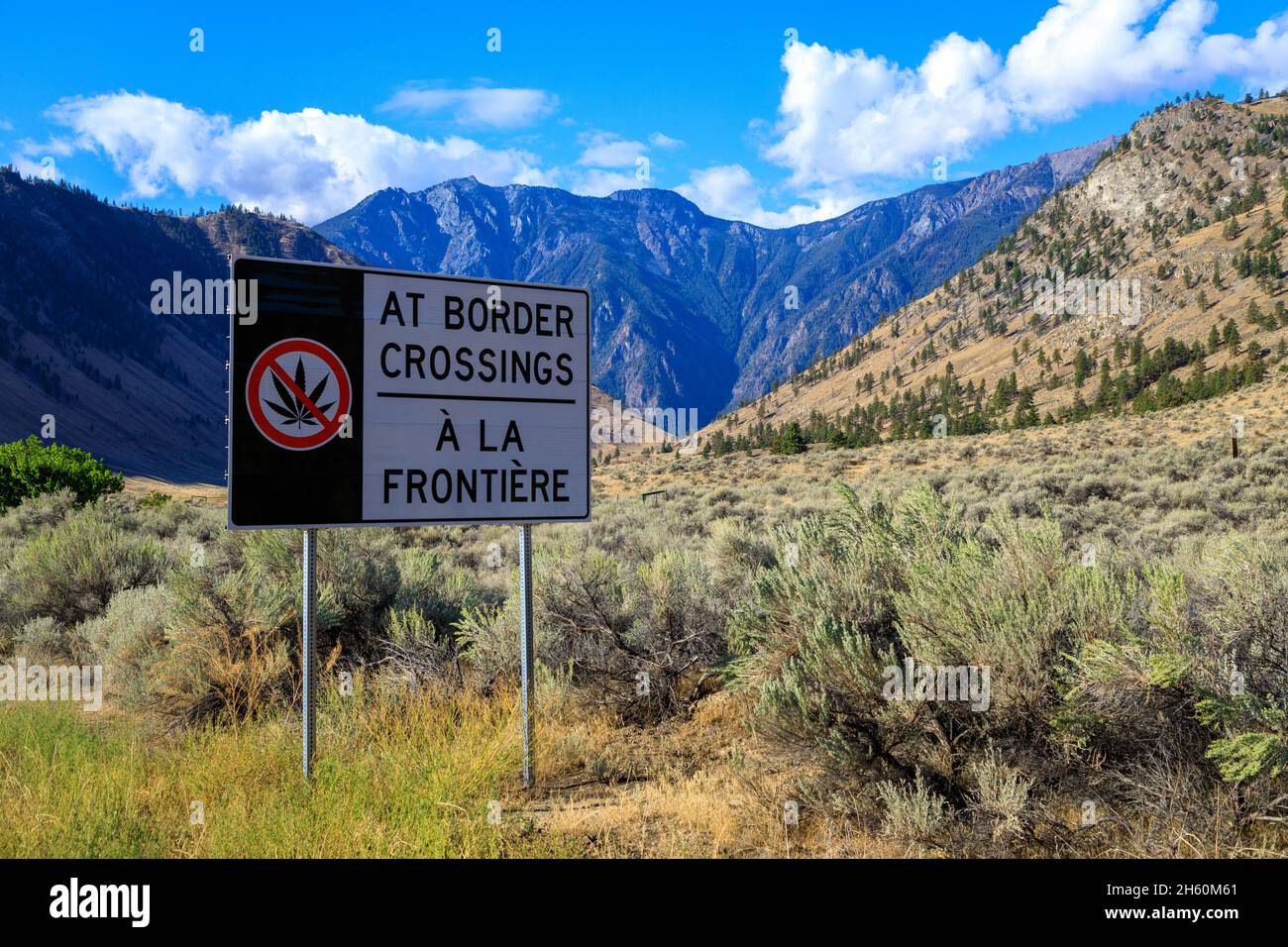 A red do not warning sign about crossing the border with marijuana at