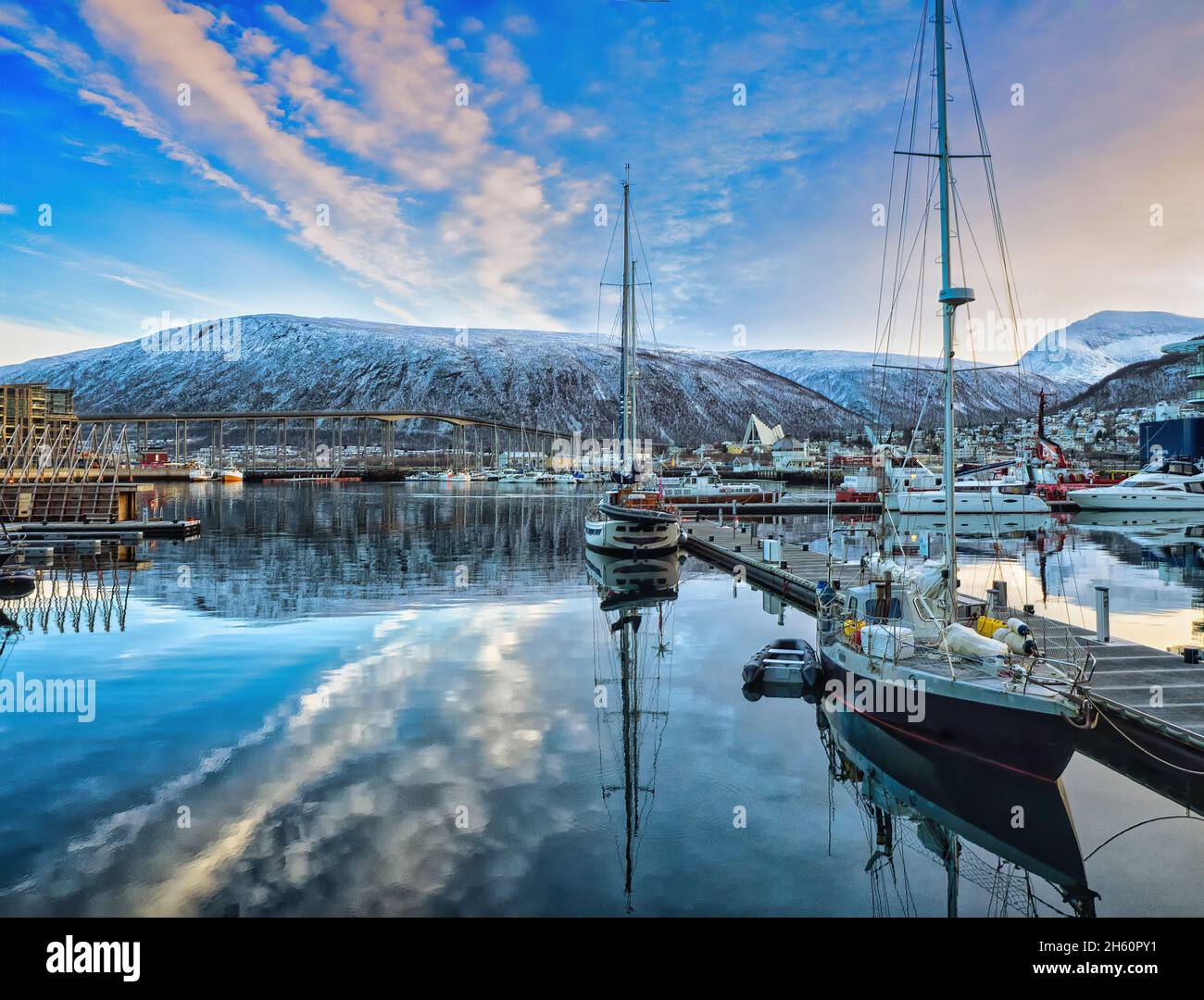 Looking across the harbour in Tromso towards Tromsdalen, with Tromso Bridge and the iconic Arctic Cathedral forming the backdrop. Stock Photo